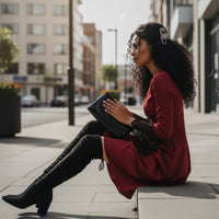 Black knee-high boots on a blurred city street background