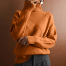 Person wearing a brown knitted sweater against a brown background