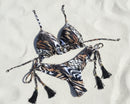 Leopard print bikini set on a white sand beach