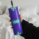 Hand holding a purple tumbler with green geometric pattern on a white background