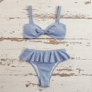 Blue bikini set on a distressed wooden surface