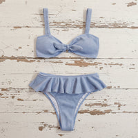 Blue bikini set on a distressed wooden surface