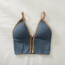 Blue bikini top with brown straps on a light background