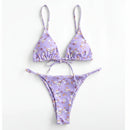 Purple floral bikini set on a white background