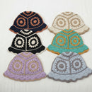 Set of six colorful crocheted hats on a white background