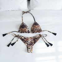 Leopard print bikini set with tassels on a white surface