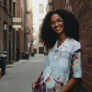 Person wearing a colorful patterned shirt and light jeans standing in an alleyway