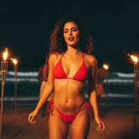 Red bikini set on a wooden surface