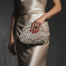 Elegant clutch bag with crystal embellishments on a smoky grey background