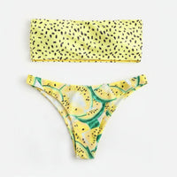 Yellow bikini set with leaf pattern on a white background