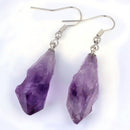 Purple crystal earrings on a white background