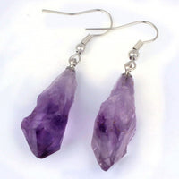 Purple crystal earrings on a white background