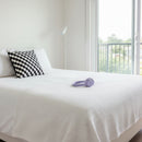 Black and white checkered pillow on a white background