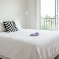 Black and white checkered pillow on a white background