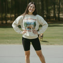 Beige sweatshirt with Yellowstone National Park graphic on a hanger against a white background