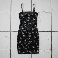 Black dress with butterfly pattern on a checkered background