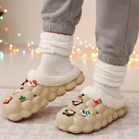 Pair of white slippers with decorative elements on a checkered floor.