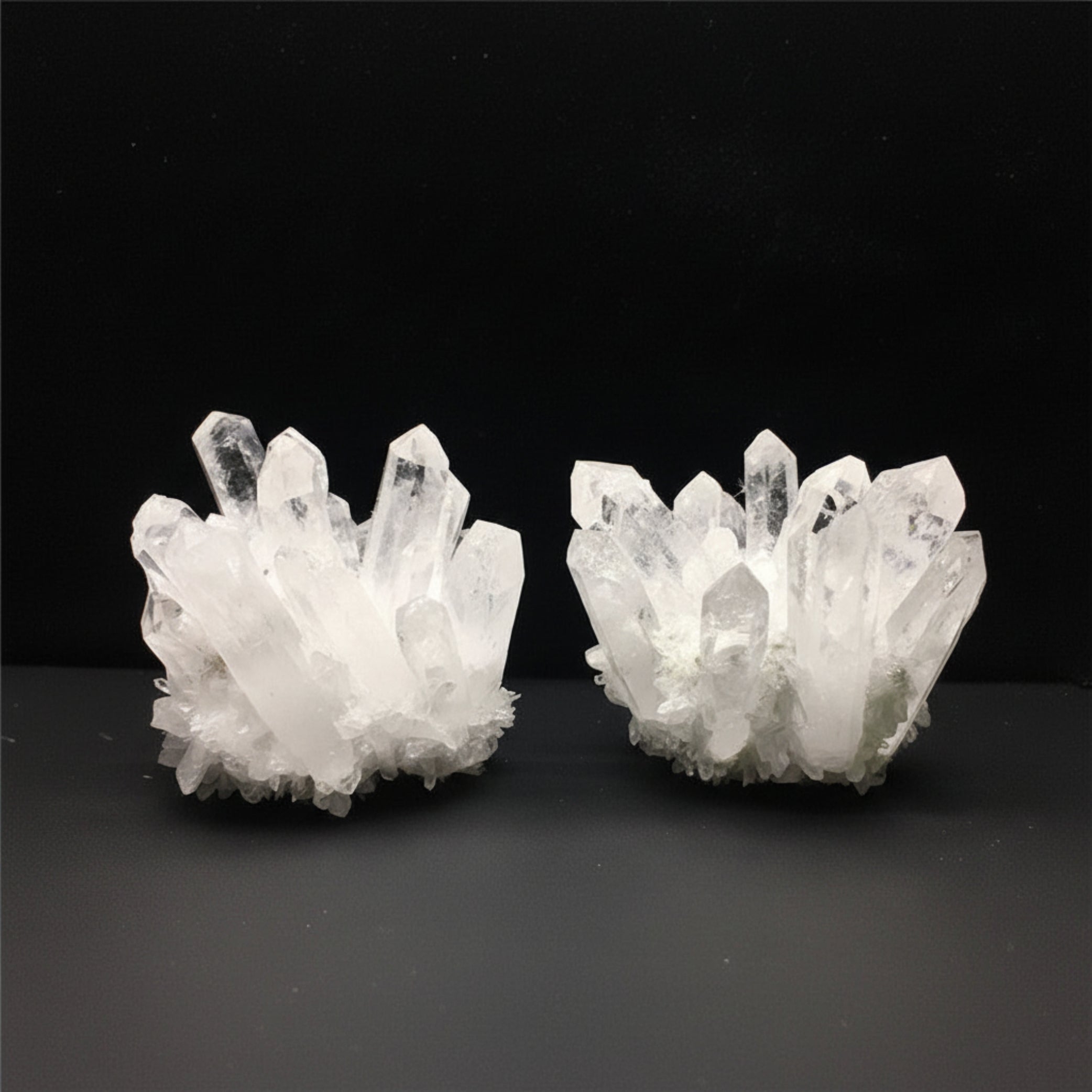 Two crystal formations on a dark background