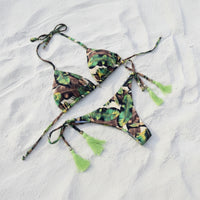 Tropical leaf patterned bikini set on white sand beach