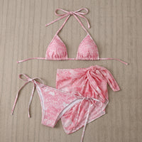 Pink bikini set on a black and white checkered background