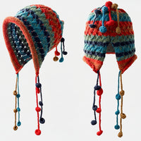 Colorful knitted hats with hanging decorations on a beige background, featuring the brand 'WEIAI'.