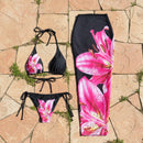 Black bikini set with pink floral design on a white background