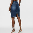 Person wearing a blue denim skirt with a blurred background