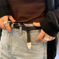 Person adjusting a belt with a focus on the waist area.