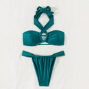 Teal bikini set on a textured white background