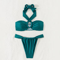 Teal bikini set on a textured white background