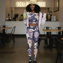 Woman in a patterned outfit holding a drink in a casual setting