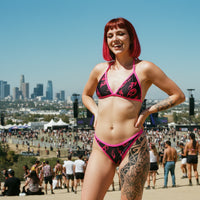 Black bikini with pink flames on sand