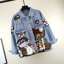 A blue denim jacket with sequin patches and cartoon flowers embroidered on the back.