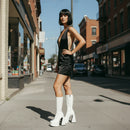 White platform boots with high heels on a neutral background