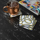 Copper mug with steam on a colorful coaster, next to a magazine on a wooden surface