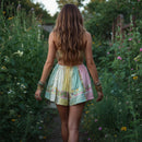 Person wearing a patchwork skirt with floral patterns in a natural setting