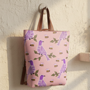 Pink backpack with bird and bee pattern on a white background