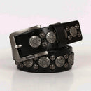 Black leather belt with silver circular studs on a light pink background