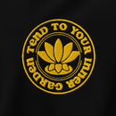 Embroidered design on a black background with yellow text and lotus flower symbol.