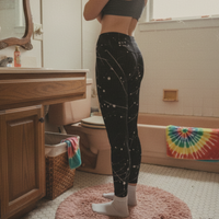 Black leggings with a starry night design on a light gray background